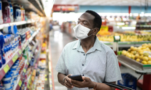 Pessoa olhando os preços no mercado, alusivo à inflação que será conhecida na agenda econômica