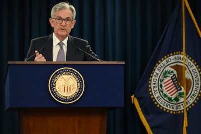 Jerome Powell, presidente do Fed, em púlpito com logo do Federal Reserve